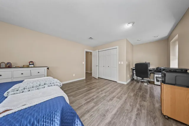 a bed room with a bed and a chair