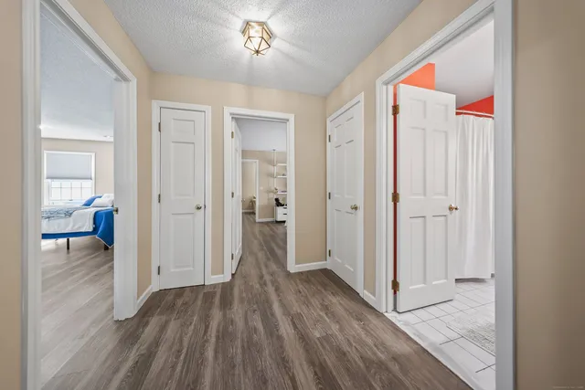 a view of hallway with wooden floor