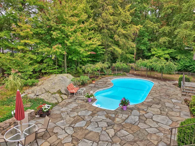a view of a backyard with swimming pool