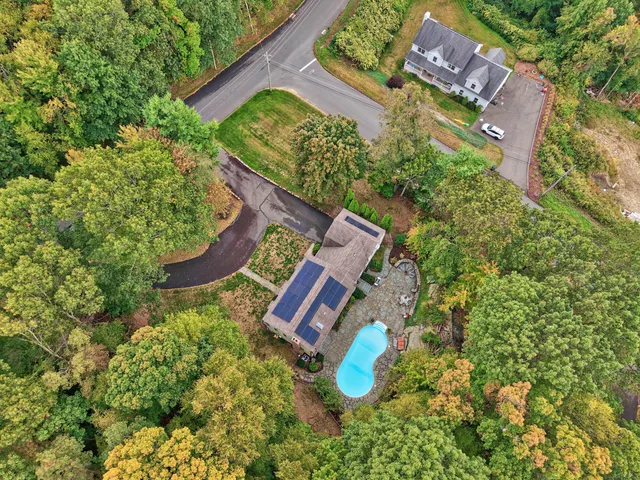 an aerial view of a house with garden space and street view