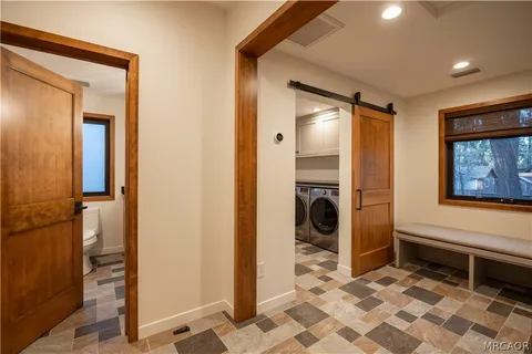 a bathroom with a granite countertop toilet sink and mirror