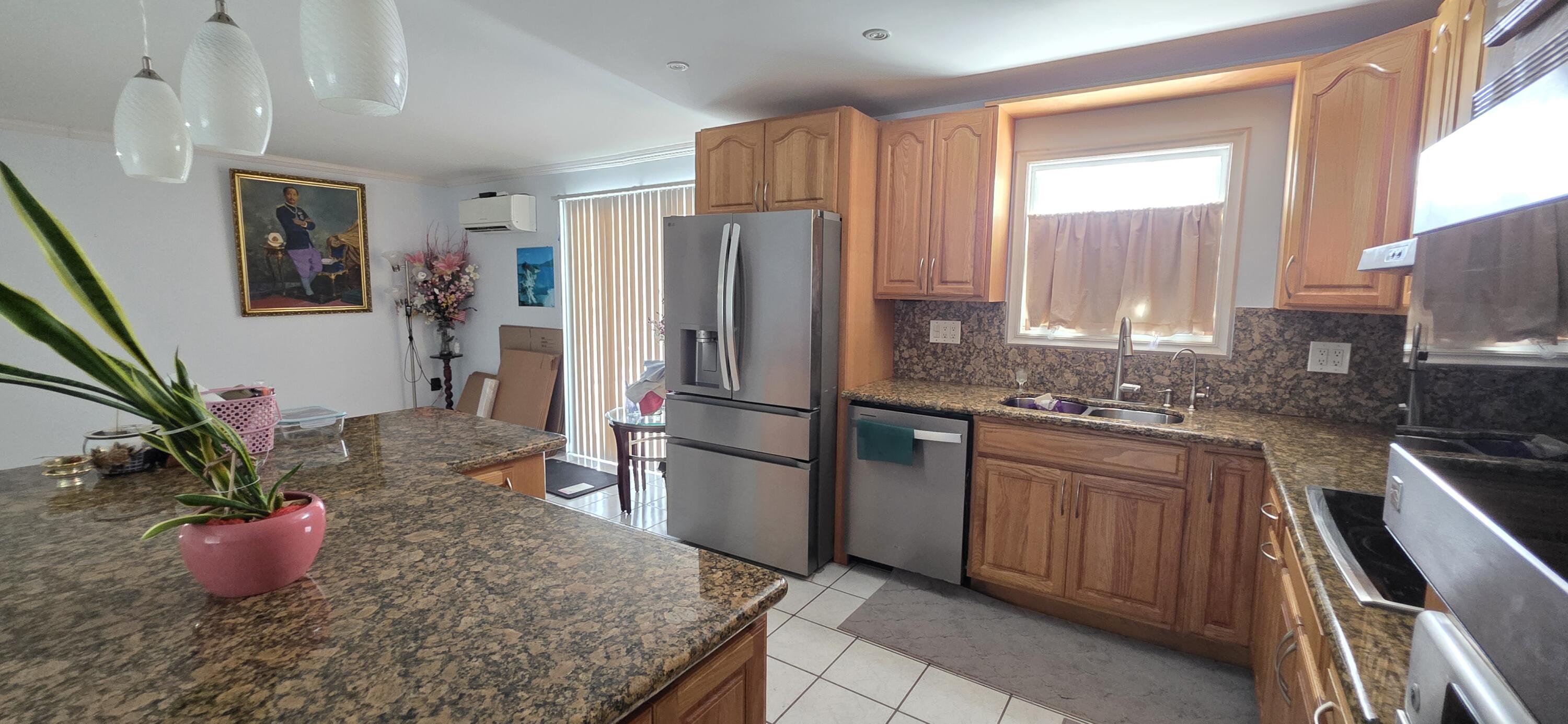 8 Emerald Drive Key West, FL 33040 - Photo 13 of 43 a kitchen with stainless steel appliances granite countertop a refrigerator sink and cabinets