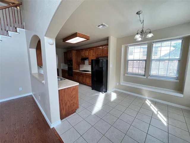 a view of entryway with kitchen island granite countertop cabinets and window