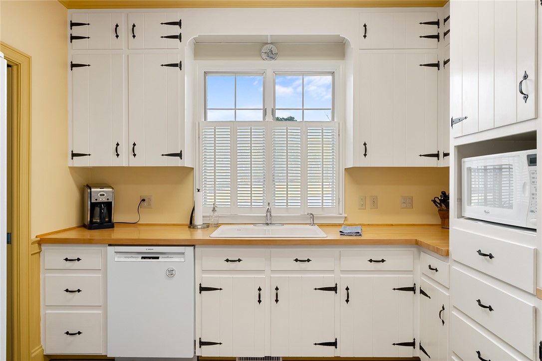 401 Berkshire Hill Anderson, SC 29621 - Photo 14 of 39 This charming kitchen features classic cabinetry, a durable wooden countertop, and ample natural light.