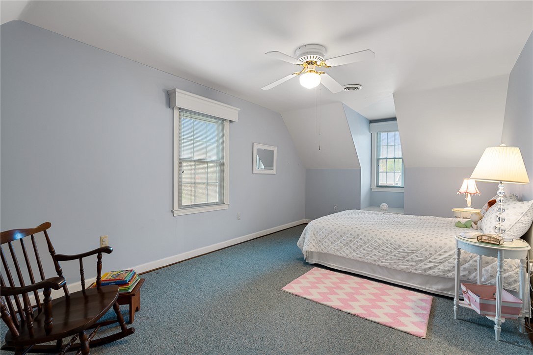 401 Berkshire Hill Anderson, SC 29621 - Photo 28 of 39 This cozy bedroom features sloped ceilings and ample natural light, creating a comfortable and inviting atmosphere.