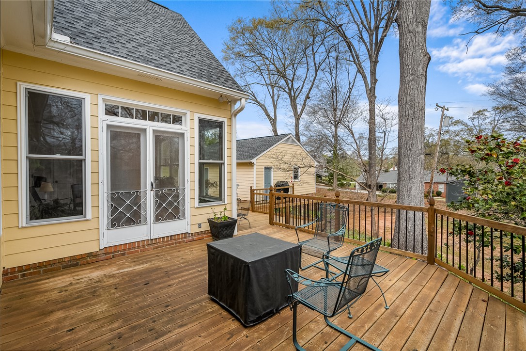 401 Berkshire Hill Anderson, SC 29621 - Photo 37 of 39 This spacious wooden deck offers serene outdoor living amidst a lush, natural setting.
