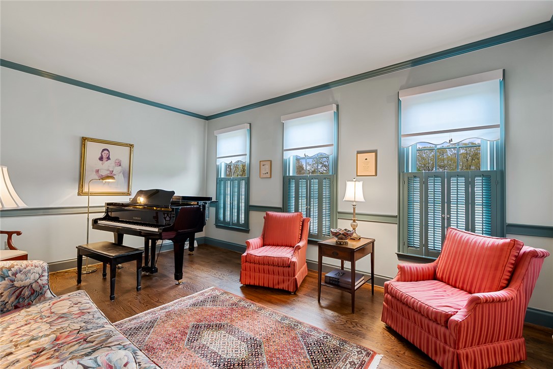 401 Berkshire Hill Anderson, SC 29621 - Photo 5 of 39 This living room features elegant wood flooring, crown molding, and bright window shutters.
