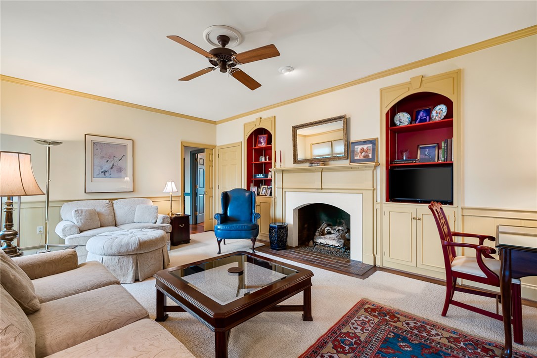 401 Berkshire Hill Anderson, SC 29621 - Photo 9 of 39 This inviting living room features a fireplace, built-in shelving, and a ceiling fan.