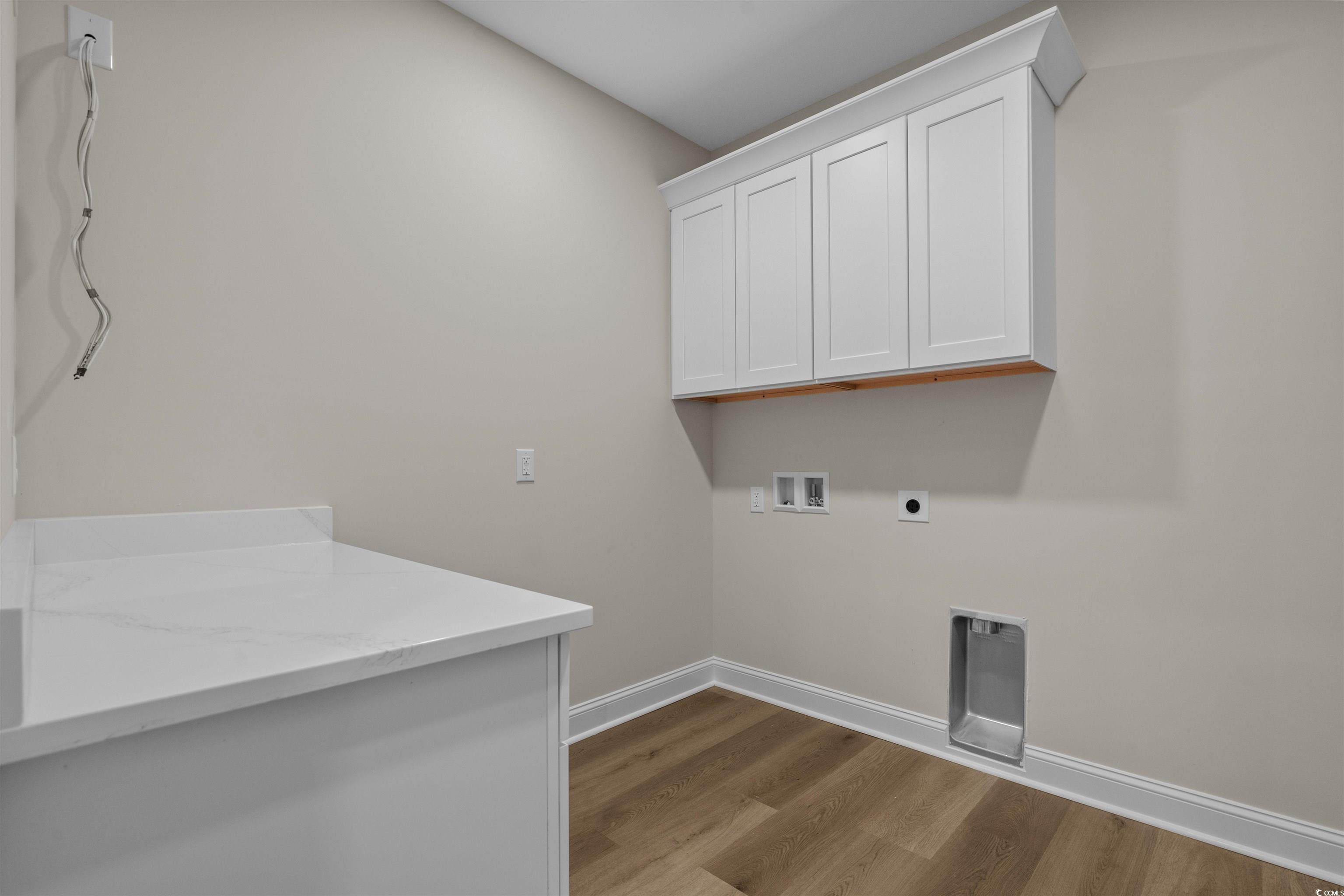 6927 Pauley Swamp Road Conway, SC 29527 - Photo 19 of 40 Laundry area featuring light wood-style floors, cabinet space, electric dryer hookup, and washer hookup