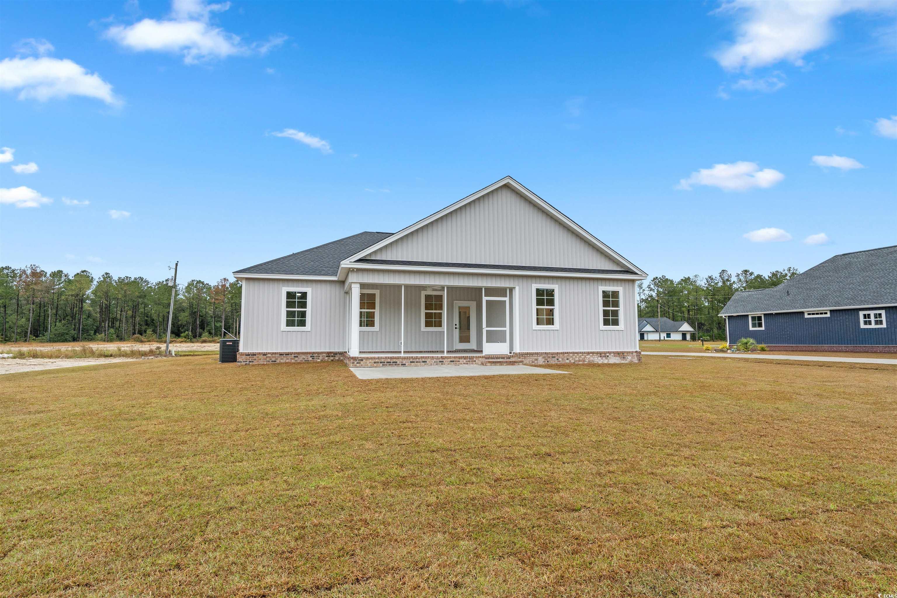 6927 Pauley Swamp Road Conway, SC 29527 - Photo 24 of 40 View of rear of house featuring a back yard and a porch