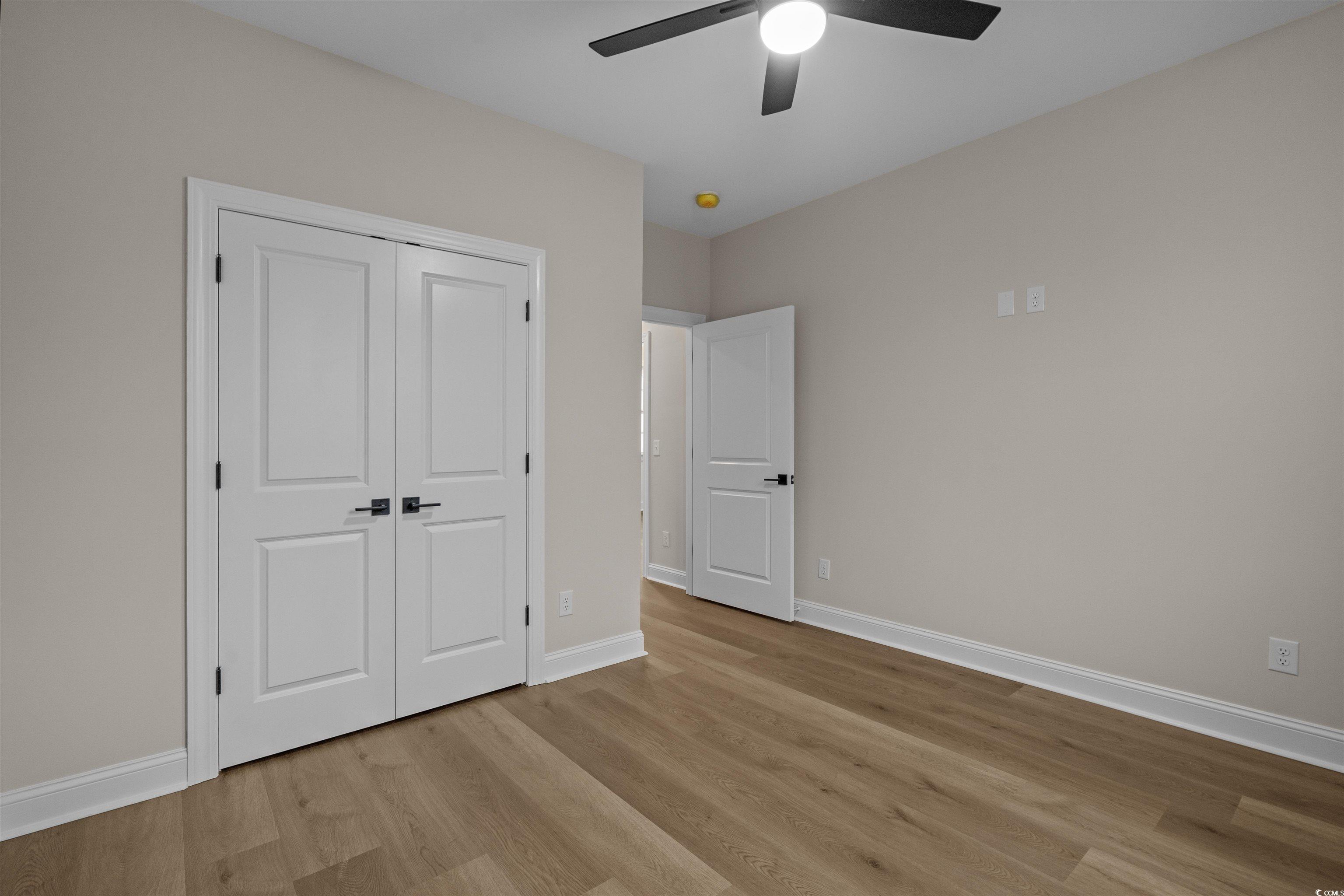 6927 Pauley Swamp Road Conway, SC 29527 - Photo 34 of 40 Unfurnished bedroom featuring light wood-type flooring, a ceiling fan, and a closet