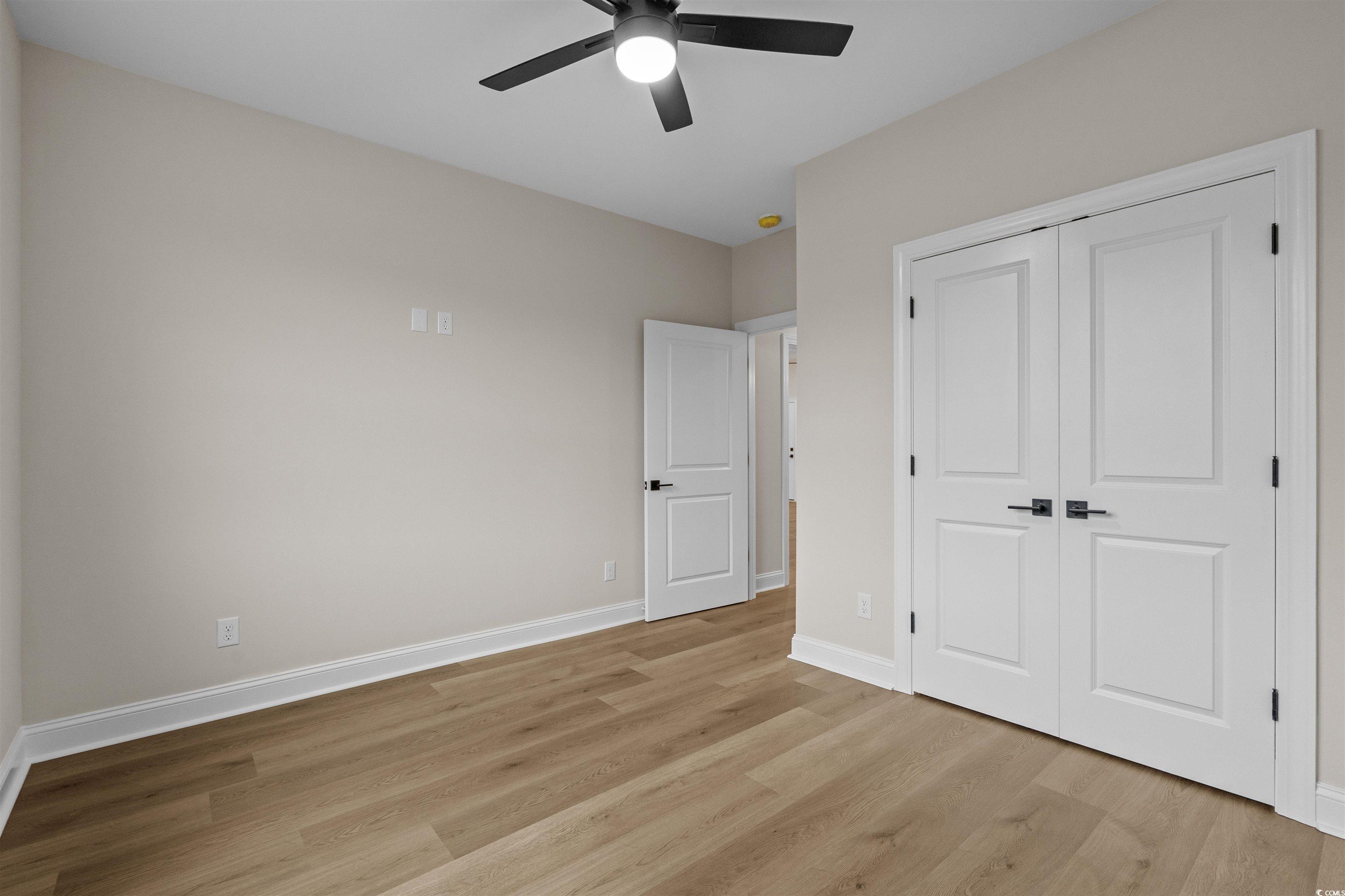 6927 Pauley Swamp Road Conway, SC 29527 - Photo 36 of 40 Unfurnished bedroom featuring light wood-style floors, a closet, and ceiling fan