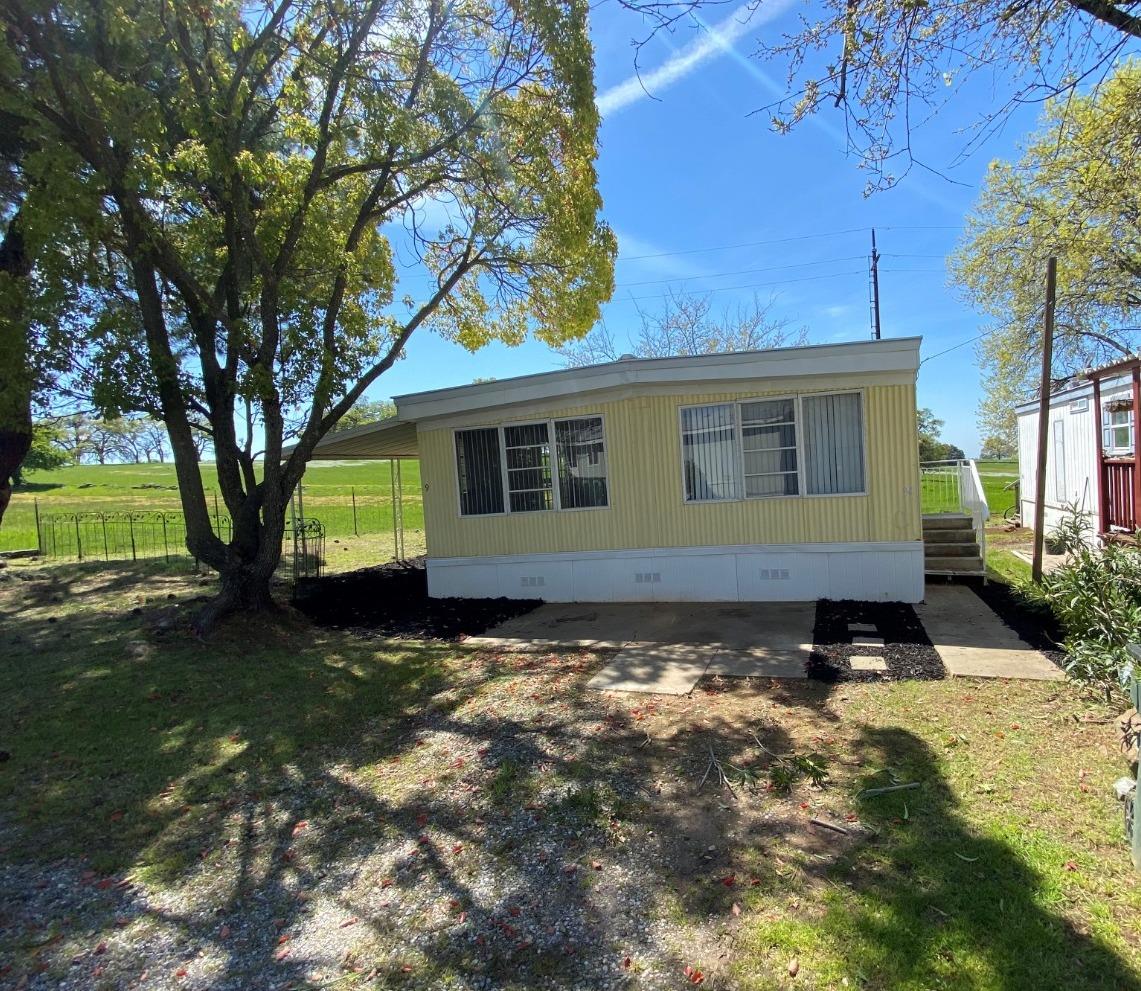 12594 Kennedy Flat Road, Unit 9 Martell, CA 95642 - Photo 1 of 1 a view of a backyard with a large tree