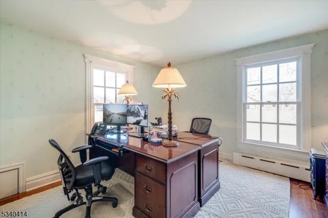 a view of a workspace with furniture and a window