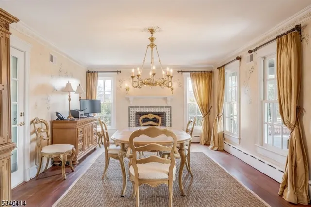 a dining room with furniture a chandelier and wooden floor