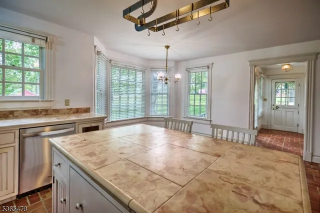 a view of a kitchen counter top space and windows