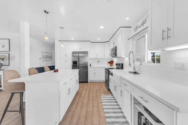 a kitchen with a sink a counter top space and cabinets
