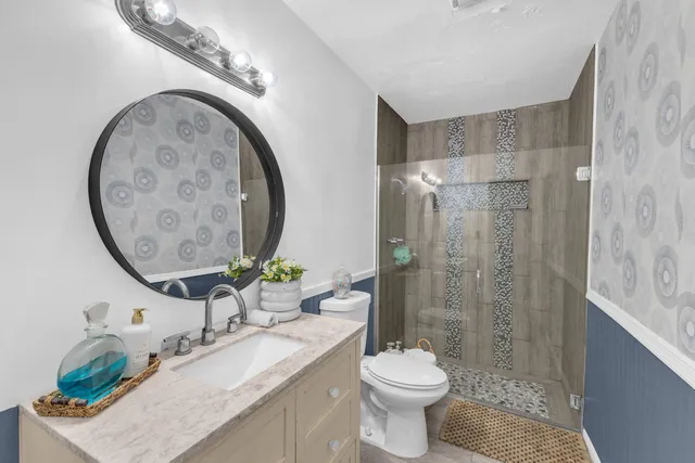 a bedroom with a bed and a flat tv screen on dresser