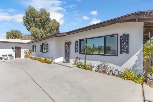 a living room with furniture wooden floor and a flat screen tv