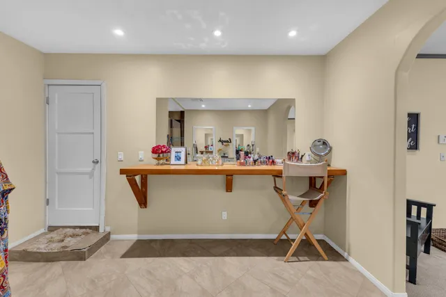 a view of patio with table and chairs under an umbrella