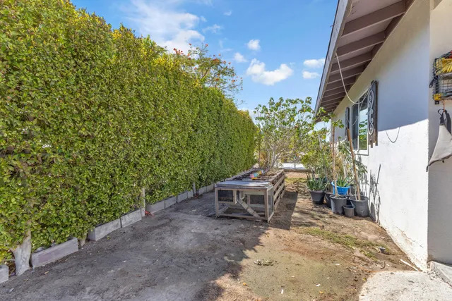 a view of patio with a table and chairs under an umbrella with a couch