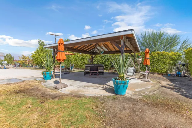 a view of a backyard with sitting area