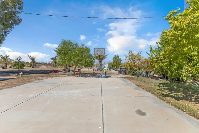 a view of a patio with table and chairs and potted plants