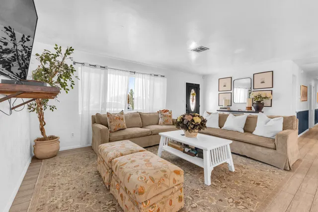 a view of a dining room with furniture window and wooden floor