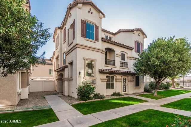 a front view of a house with a yard and trees