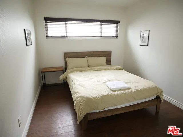 a bed sitting in a bedroom next to a window