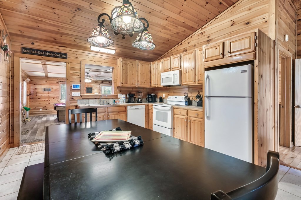 2617 Sharpes Ridge Way Sevierville, TN 37876 - Photo 18 of 43 a kitchen with a table chairs refrigerator and windows