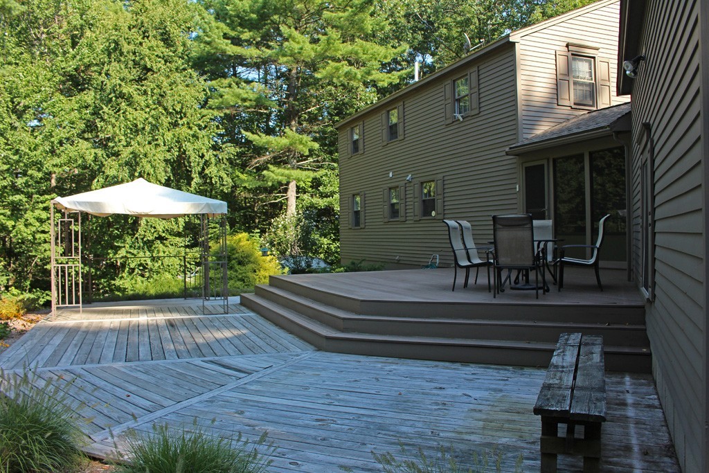 11 Bayberry Hill Road Townsend, MA 01469 - Photo 15 of 21 a backyard of a house with table and chairs