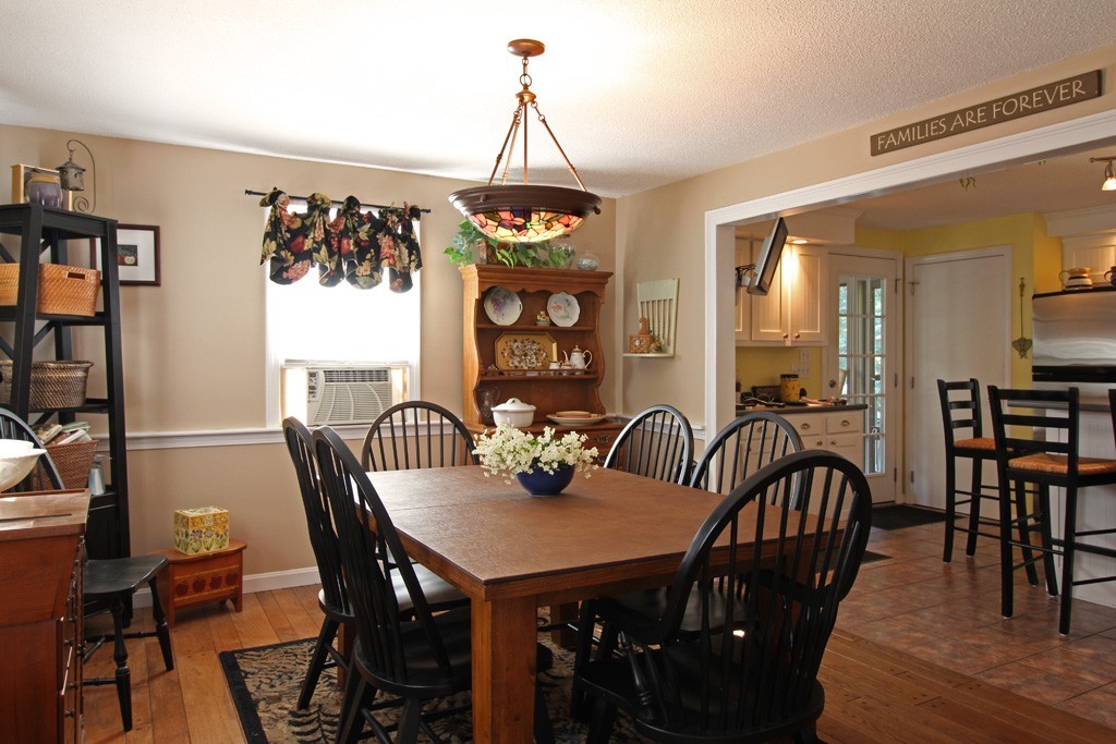 11 Bayberry Hill Road Townsend, MA 01469 - Photo 3 of 21 a view of a dining room and livingroom with furniture wooden floor a rug a painting and a chandelier