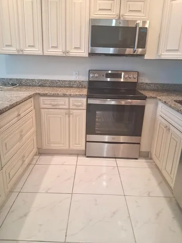 a stove top oven sitting inside of a kitchen