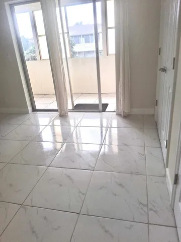 a view of an empty room with a window