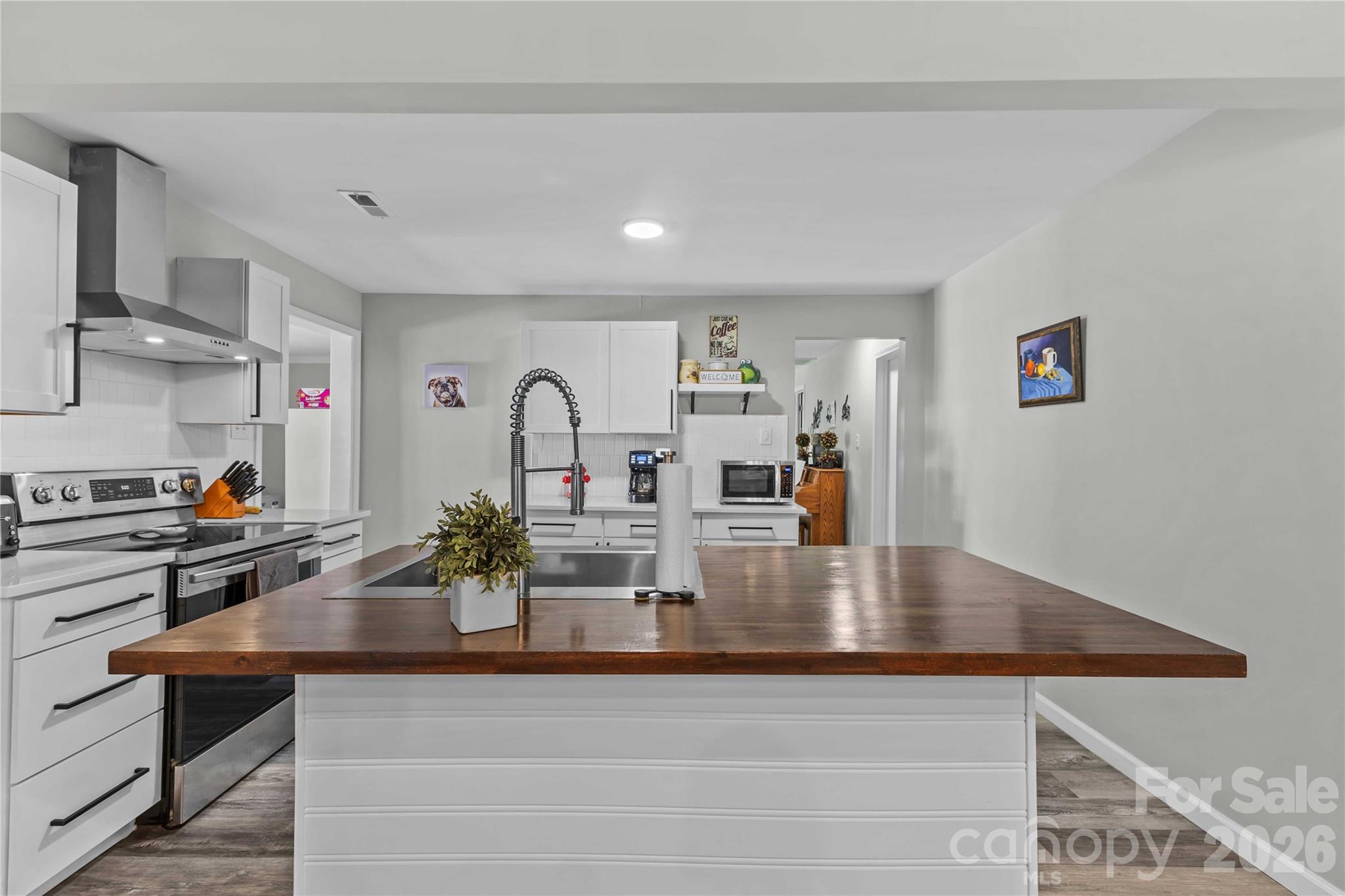 2341 Dixon Road Belmont, NC 28012 - Photo 21 of 42 a kitchen with kitchen island a sink appliances and cabinets