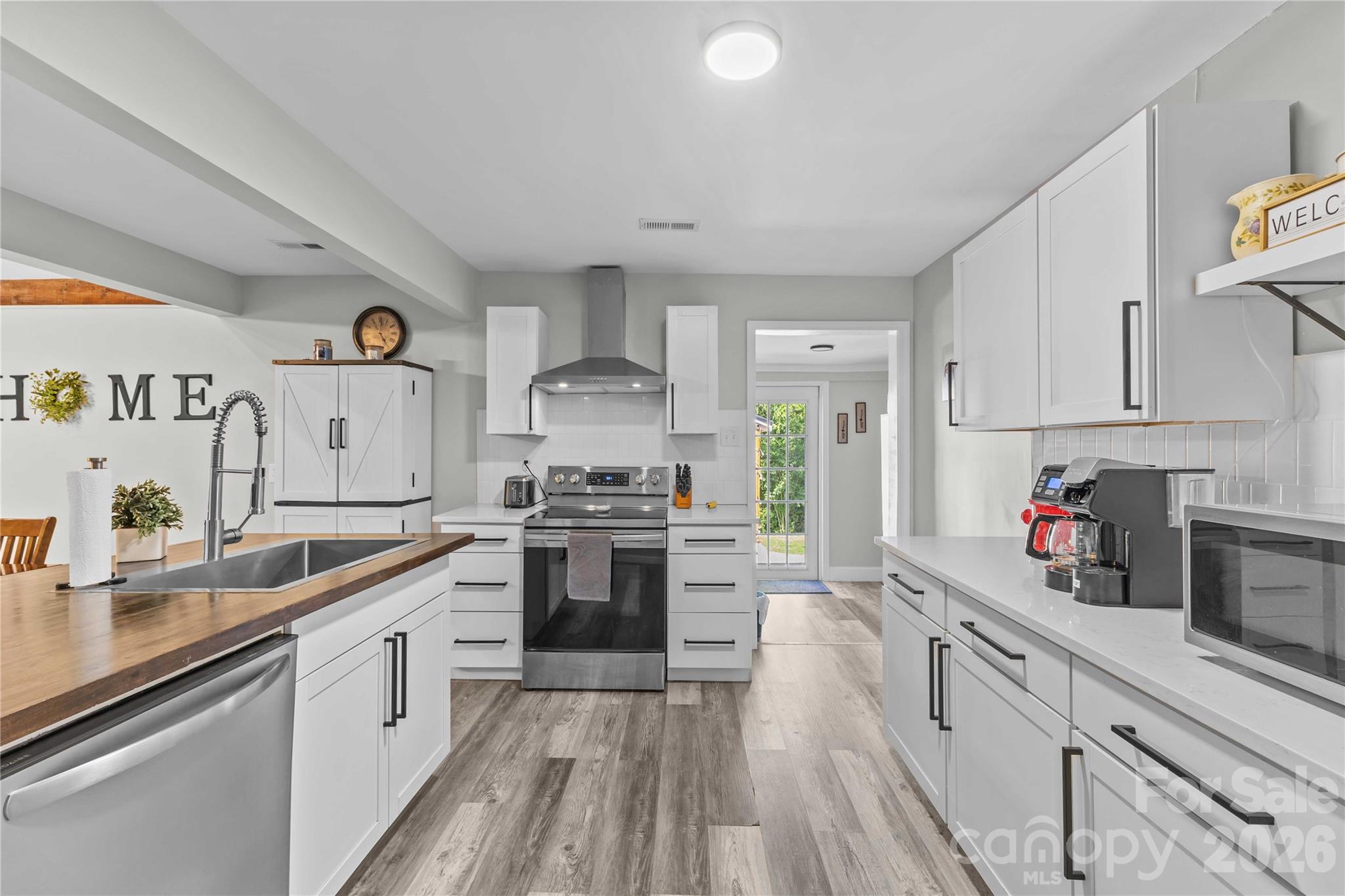 2341 Dixon Road Belmont, NC 28012 - Photo 22 of 42 a kitchen with stainless steel appliances granite countertop a sink stove and refrigerator