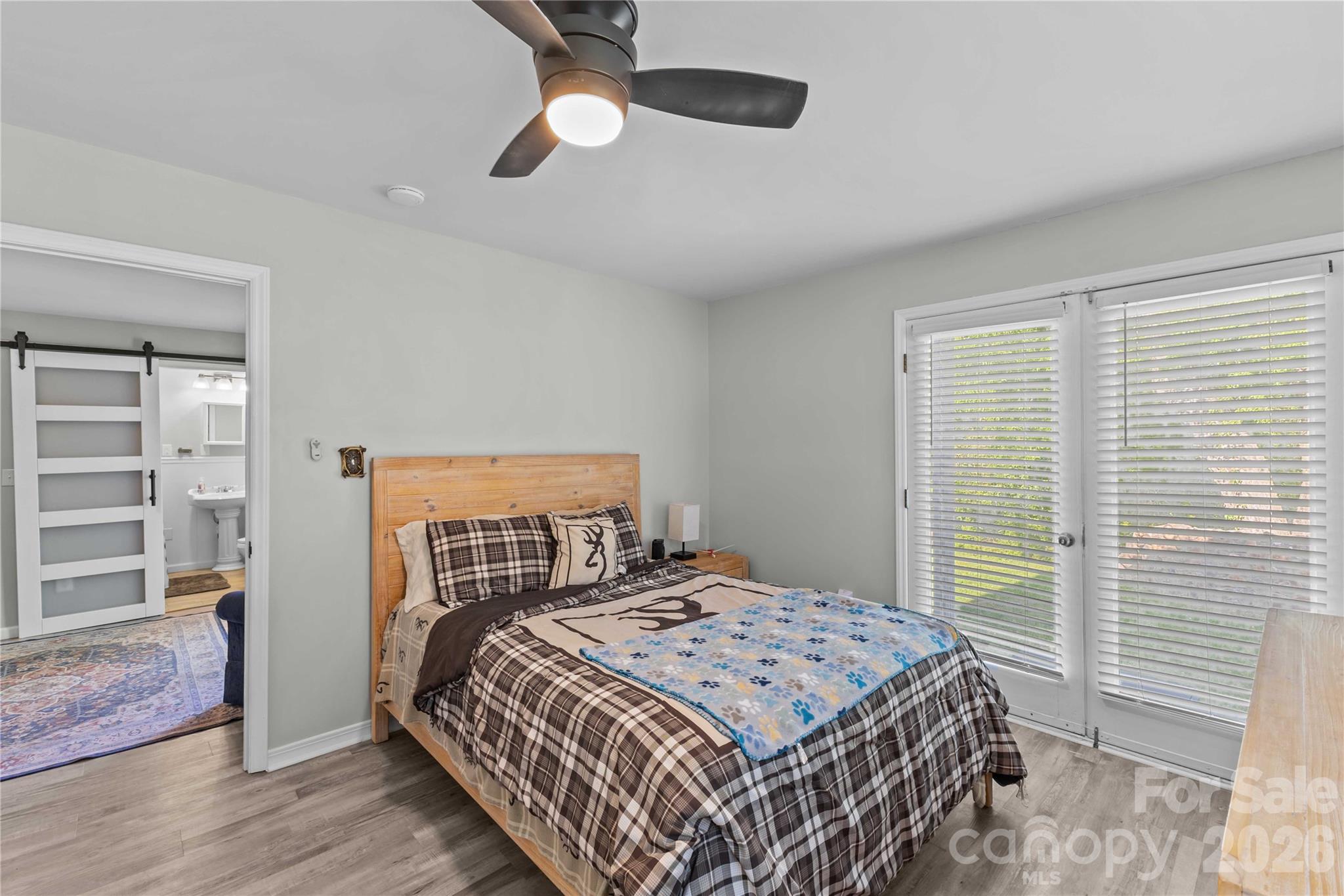2341 Dixon Road Belmont, NC 28012 - Photo 30 of 42 a bedroom with a large bed and a chandelier