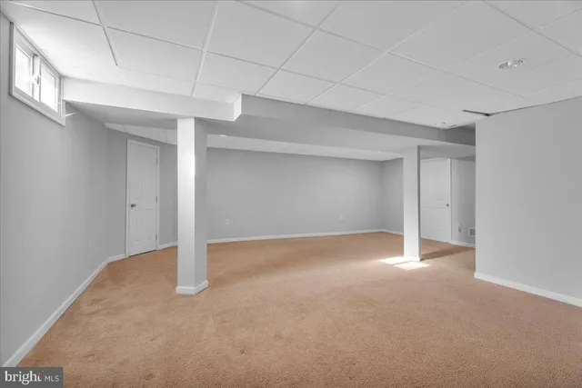 an empty room with a empty space and windows