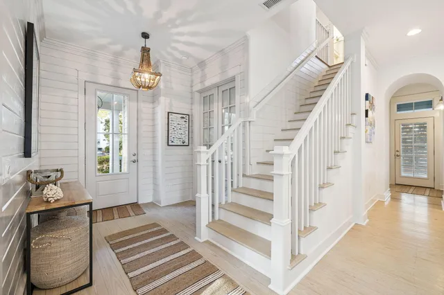 a view of entryway and hall with wooden floor