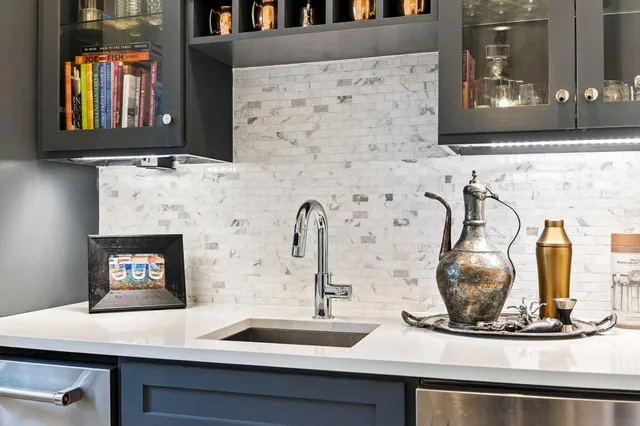 a living room with furniture a fireplace and a floor to ceiling window