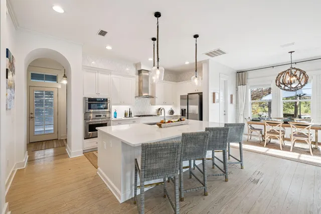 a kitchen with sink a stove and refrigerator