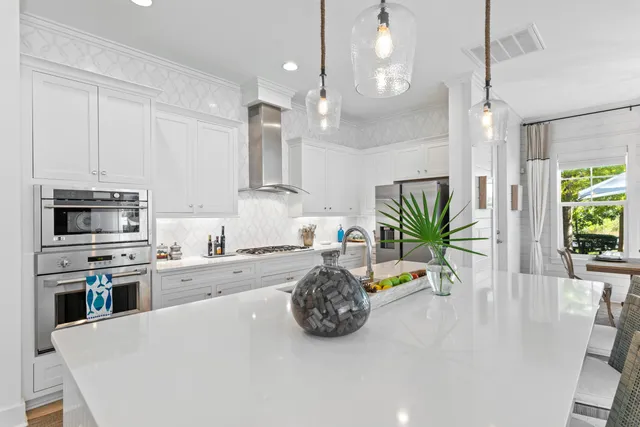 a large kitchen with kitchen island a sink stainless steel appliances and cabinets