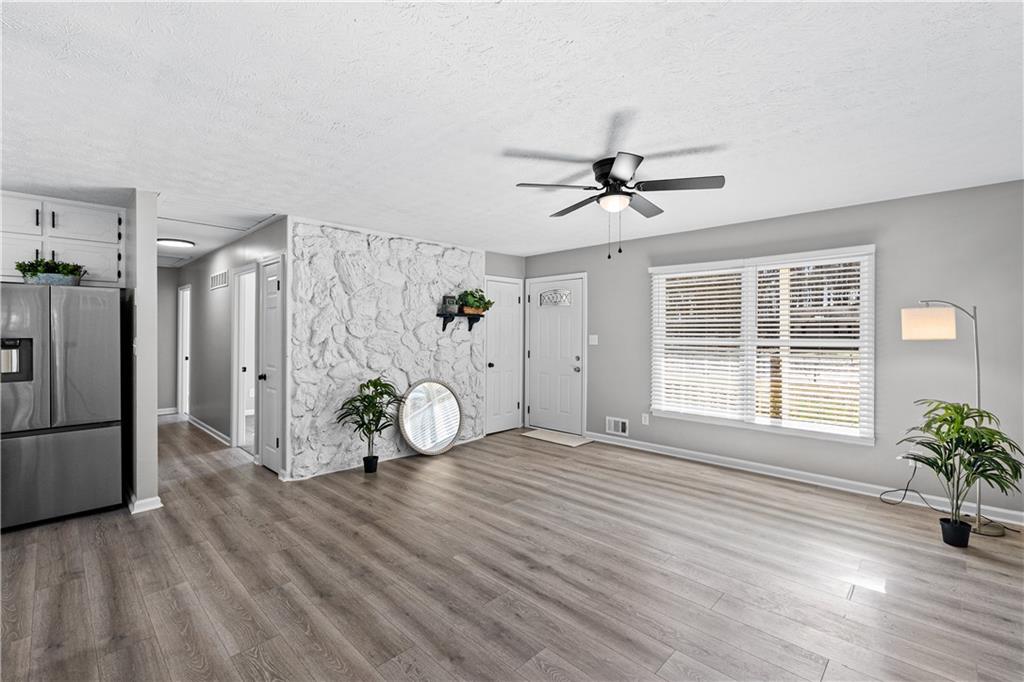 114 Vincent Avenue Stockbridge, GA 30281 - Photo 13 of 23 a view of livingroom with hardwood floor and a ceiling fan