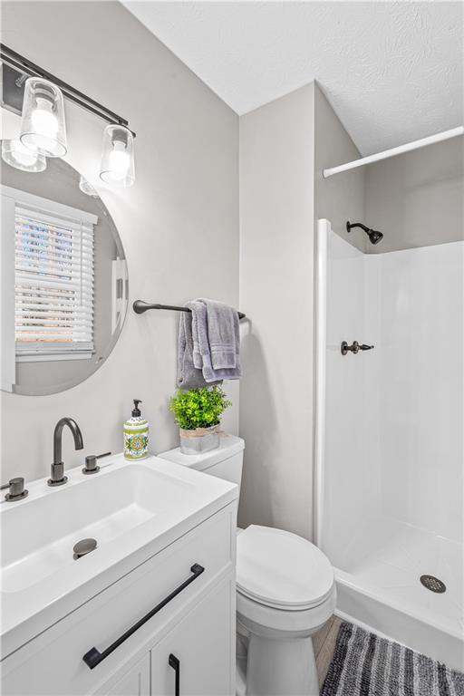 114 Vincent Avenue Stockbridge, GA 30281 - Photo 19 of 23 a bathroom with a sink toilet a mirror and shower