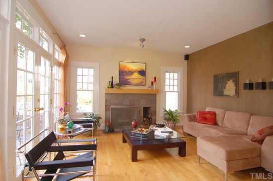 2718 Cambridge Road Raleigh, NC 27608 - Photo 3 of 12 a living room with furniture fireplace and a large window