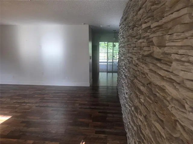 a view of wooden floor and brick walls