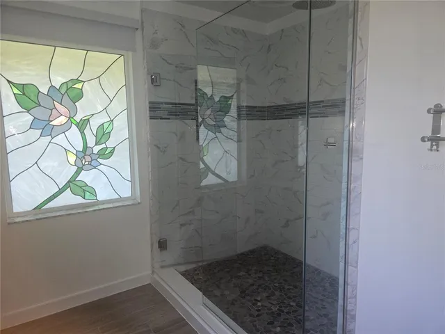 a bathroom with a glass shower door