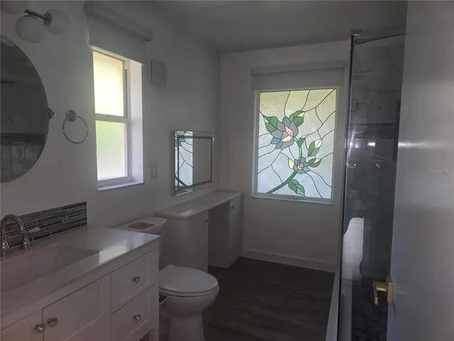 a bathroom with a toilet sink and mirror