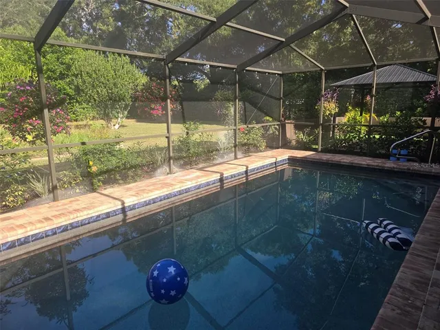 a backyard of a house with a garden and tree